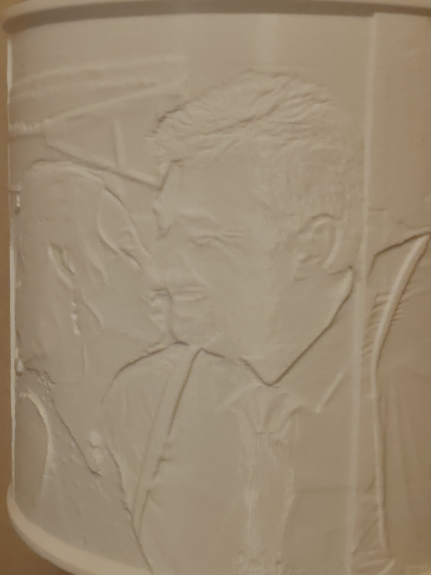 Close-up of an unlit Sammy & Me lamp showing the sculpted 3D carving of a couple